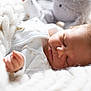 baby, newborn, sleeping, blanket, knit, soft_toy, cozy, infant, peaceful, closeup, face, skin, cute, indoors, rest, child, portrait, warm, comfort, sleep