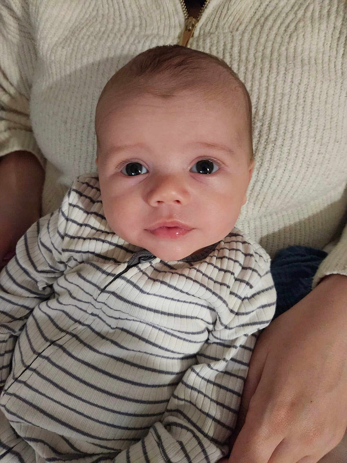 Cooper joined the competition — help win amazing prizes! baby, infant, striped_clothing, person, face, eyes, hand, sweater, knitwear, closeup, portrait, child, cute, skin, expression, indoor, holding, young, newborn, resting