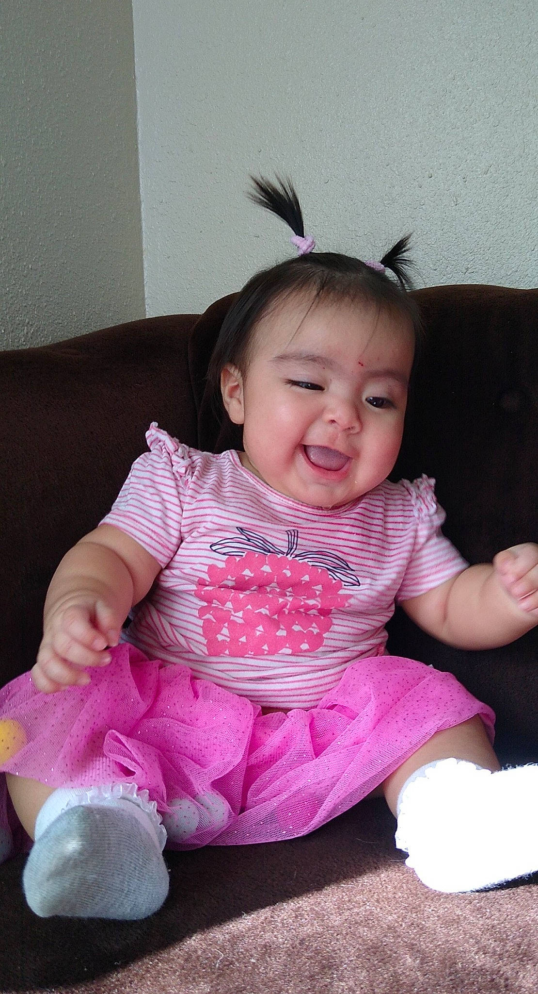 Xiomara joined the competition — help win amazing prizes! baby, baby_toddler_clothing, cheek, child, couch, eyelash, hair_accessory, headband, living_room, mouth, person, pink, sitting, skin, sock, toddler, tongue