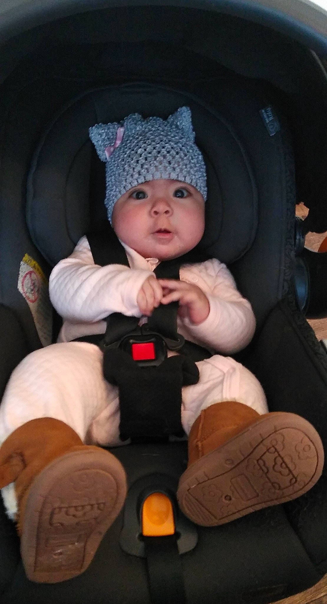 Xiomara is registered to the contest to win money with this photo: baby, baby_in_car_seat, baby_products, baby_toddler_clothing, beanie, bonnet, car_seat, child, comfort, costume_accessory, headgear, headwear, knit_cap, lap, person, product, shoe, sock, toddler, walking_shoe