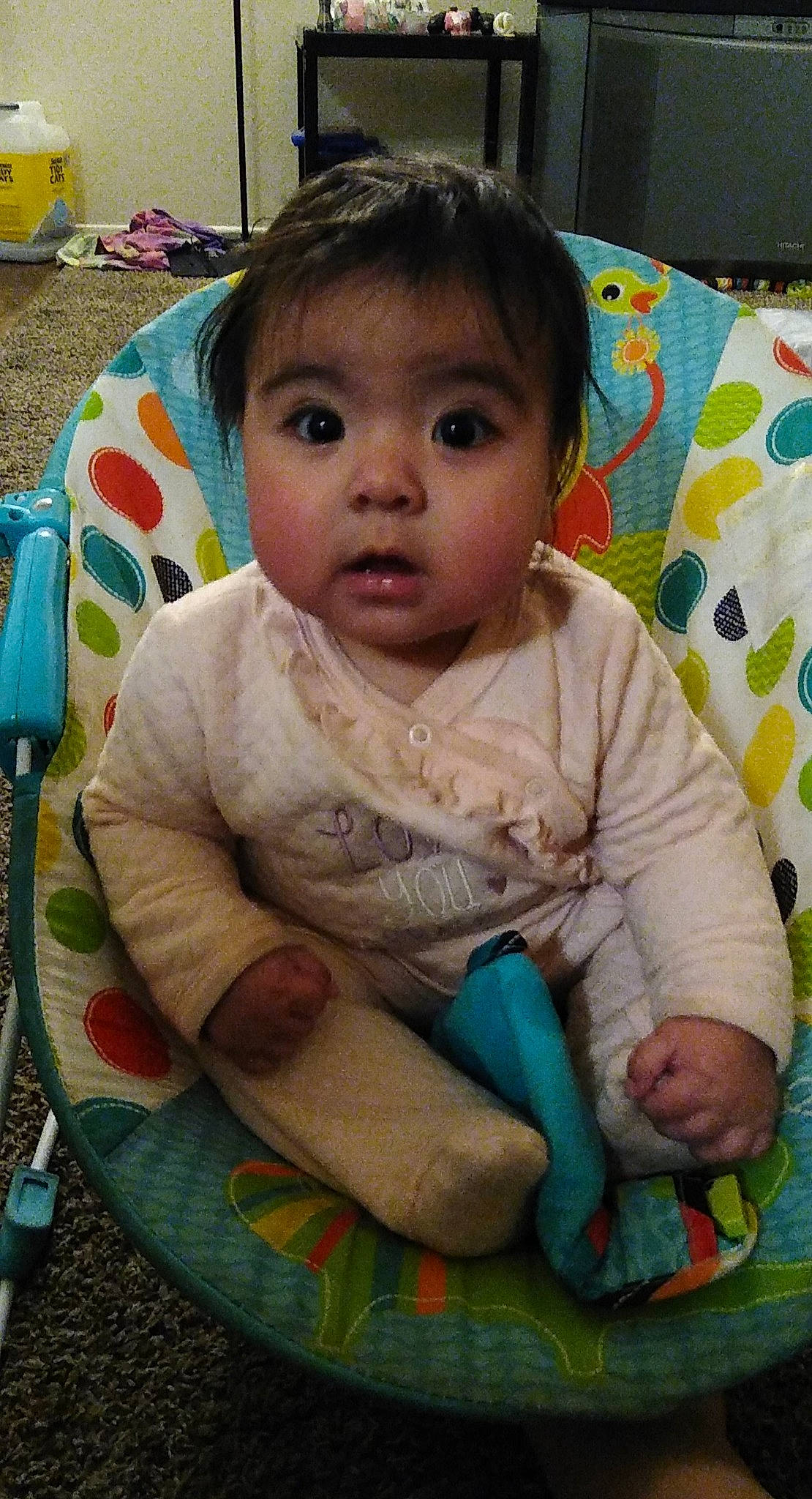 Xiomara is registered to the contest to win money with this photo: baby, baby_products, baby_toddler_clothing, cheek, child, comfort, cutlery, eye, foot, fork, household_silver, kitchen_utensil, lap, linens, nose, person, sitting, skin, sock, surprise