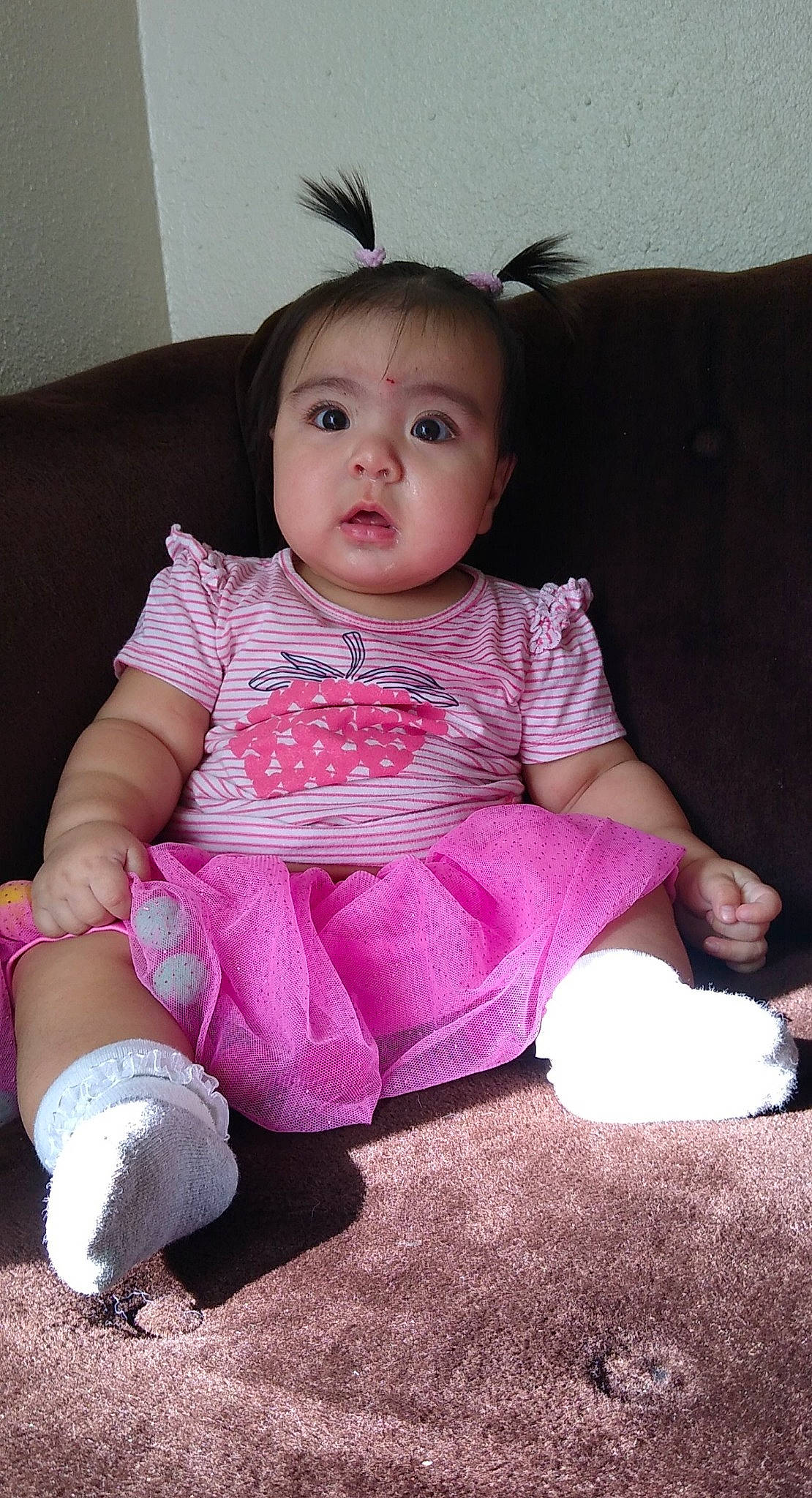 Xiomara joined the competition — help win amazing prizes! ankle, baby, baby_toddler_clothing, cheek, child, comfort, couch, foot, hair_accessory, headband, human_body, lap, living_room, mammal, nail, person, pink, sitting, skin, sock