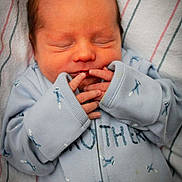 Morgan is registered to the contest to win money with this photo: newborn, baby, sleeping, onesie, blue_clothing, infant, blanket, hands, fingers, face, closed_eyes, soft_texture, striped_blanket, cute, portrait, indoors, peaceful, photography_watermark, child, cozy