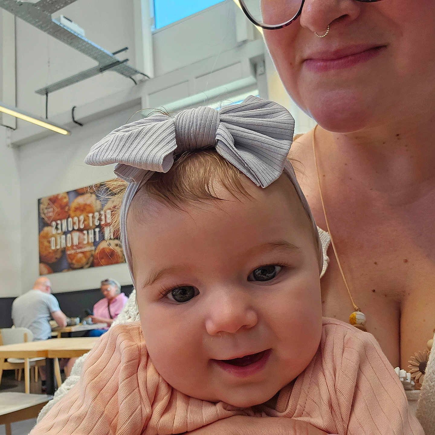 Rosie is registered to the contest to win money with this photo: accessories, adult, baby, bodypart, chair, face, finger, furniture, glasses, hand, head, jewelry, male, man, necklace, people, person, photography, portrait, wood