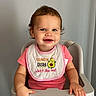 Athena joined the competition — help win amazing prizes! toddler, child, high_chair, smiling, pink_clothing, bib, indoor, happy, baby, person, furniture, seat, young_child, cute, portrait, sitting, face, human, casual, light