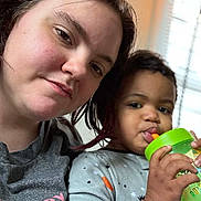 Rihannon joined the competition — help win amazing prizes! woman, toddler, child, face, drinking, cup, straw, indoor, natural_light, casual_clothing, portrait, closeup, together, family, love, smile, home, window_blinds, relaxed, skin