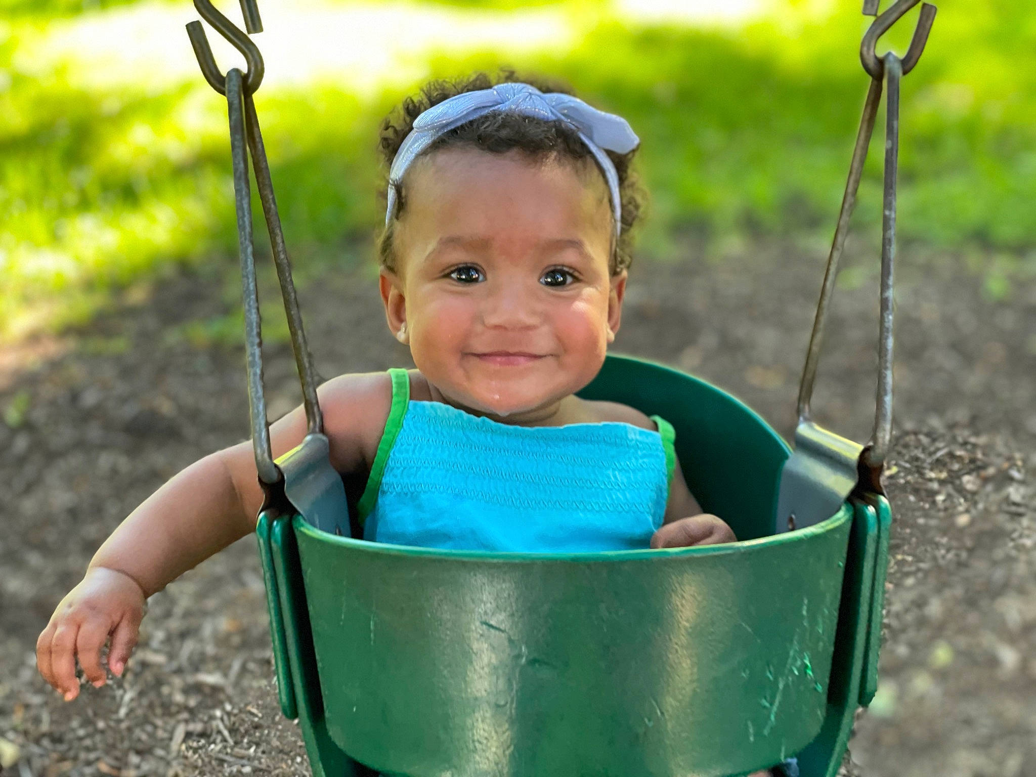Kymori joined the competition — help win amazing prizes! baby, face, facial_expression, grass, happy, joy, leaf, mammal, natural_environment, nature, people_in_nature, person, photograph, plant, product, skin, smile, sunlight, swing, toddler