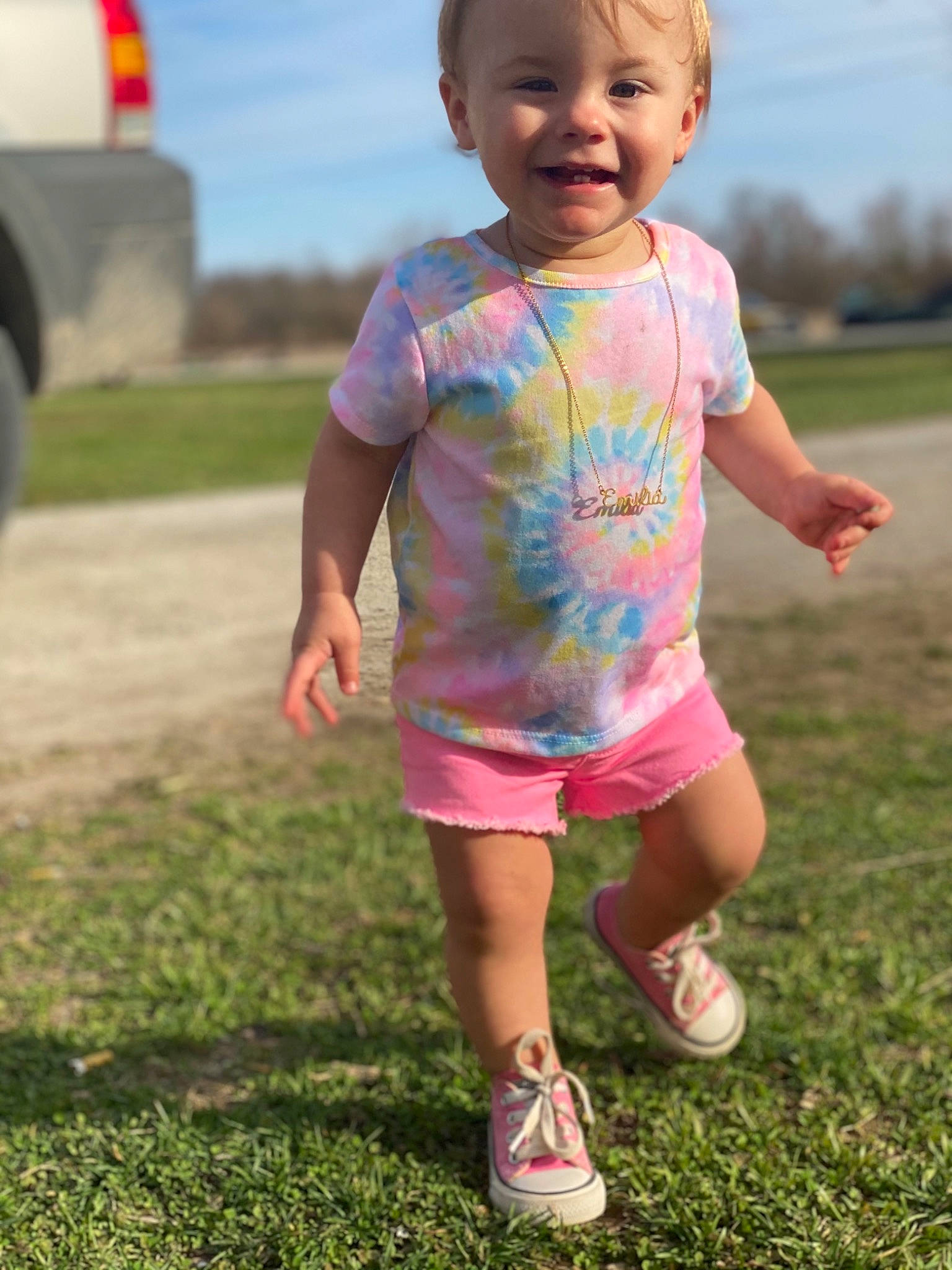 Emmie Lou is registered to the contest to win money with this photo: baby_toddler_clothing, child, finger, fun, grass, grassland, happy, head, joy, leisure, people, people_in_nature, person, pink, recreation, shorts, sky, sleeve, smile, standing