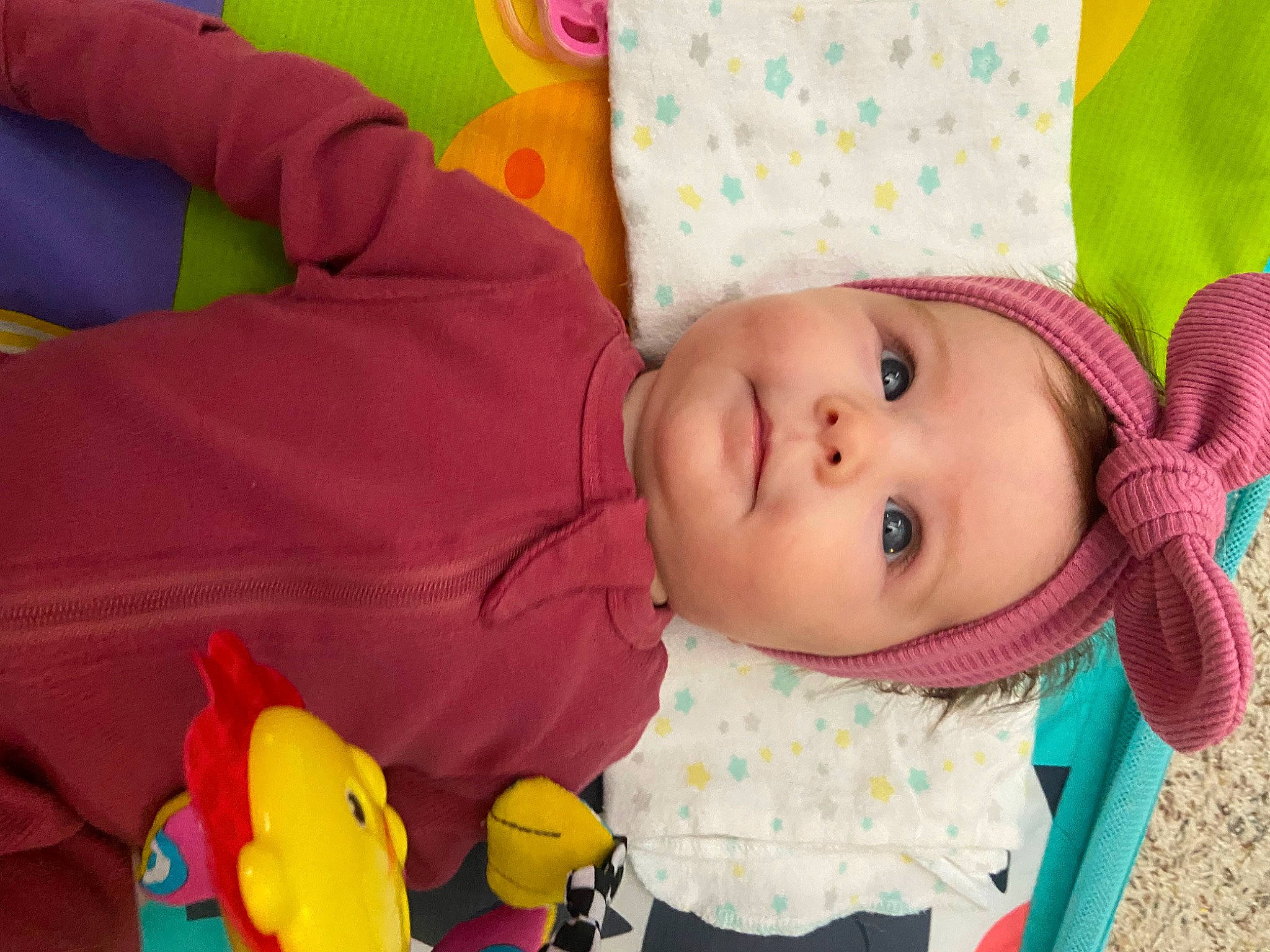 Lillian is registered to the contest to win money with this photo: baby, baby_products, baby_toddler_clothing, baby_toys, cheek, child, fun, happy, hat, head, headwear, nose, pattern, person, pink, product, room, skin, textile, toddler