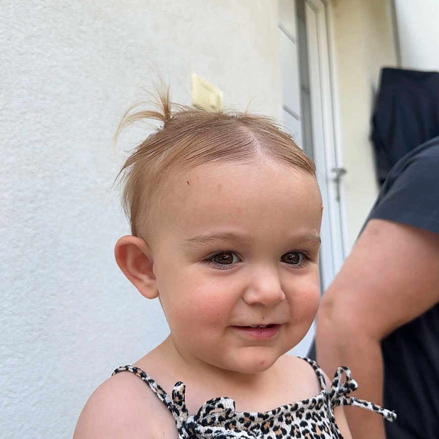 Keila joined the competition — help win amazing prizes! adult, baby, casual, child, cute, door, dress, face, hair, happy, leopard_print, outdoor, person, shoulder, skin, smiling, standing, toddler, wall, young