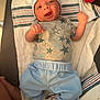 Liam is registered to the contest to win money with this photo: baby, infant, child, clothing, hat, shirt, pants, blanket, striped, socks, lying_down, happy, face, smile, hand, foot, indoors, person, cute, newborn