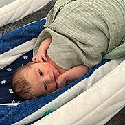 Rc Aka Reed Cameron is registered to the contest to win money with this photo: newborn, baby, infant, blanket, bassinet, bedding, blue, white, star_pattern, wrapped, sleeping, cozy, cute, small, hand, face, head, indoors, resting, child