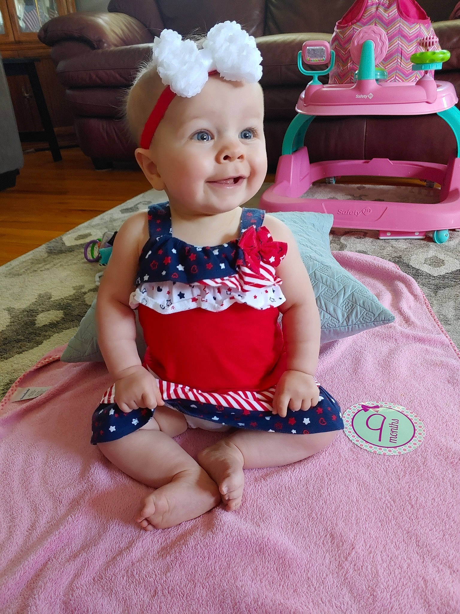 Anabelle is registered to the contest to win money with this photo: baby, baby_products, baby_toddler_clothing, child, dress, fashion_accessory, fawn, hair_accessory, headband, headgear, person, pink, play, sitting, smile, textile, toddler, toy