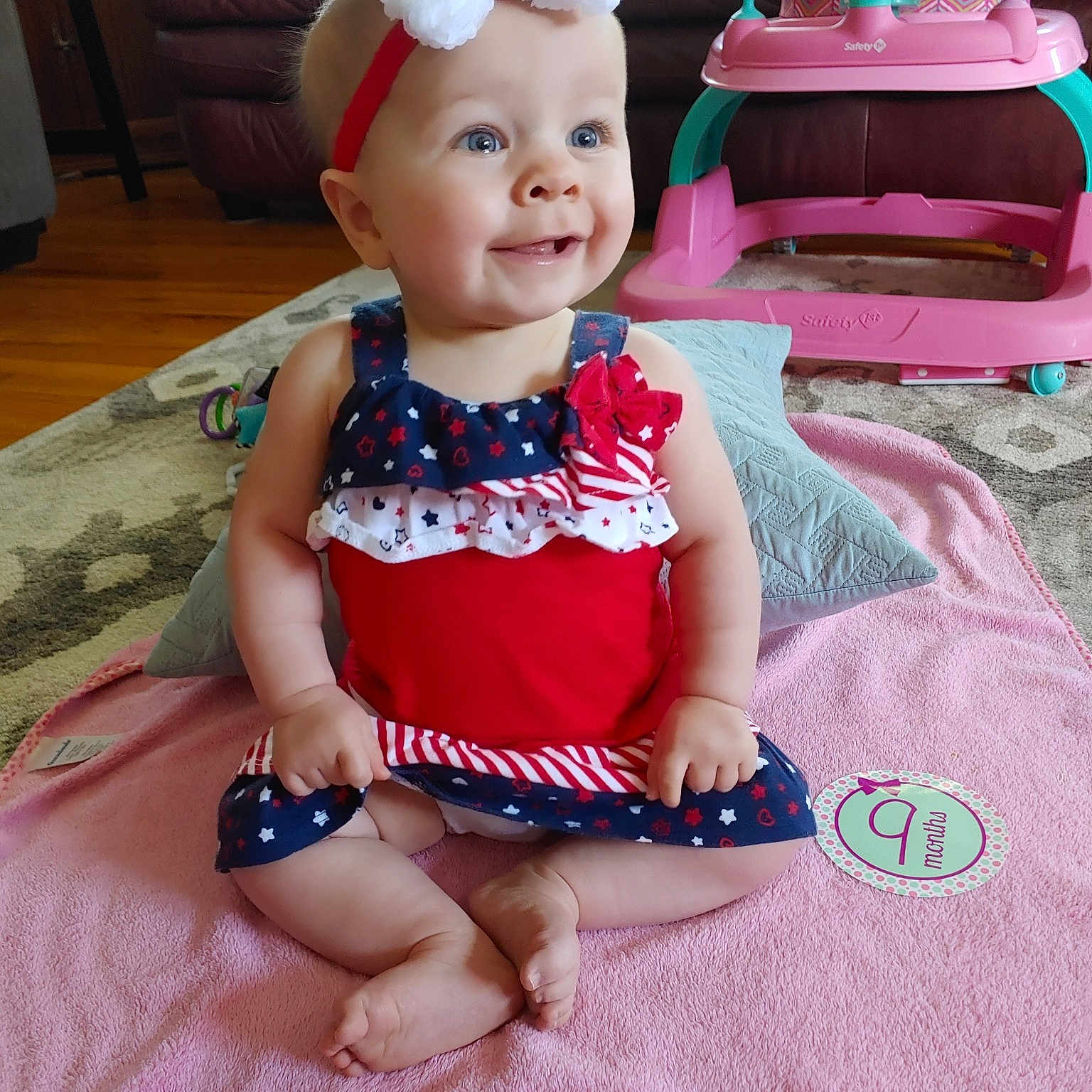 Anabelle is registered to the contest to win money with this photo: baby, baby_products, baby_toddler_clothing, child, dress, fashion_accessory, fawn, hair_accessory, headband, headgear, person, pink, play, sitting, smile, textile, toddler, toy