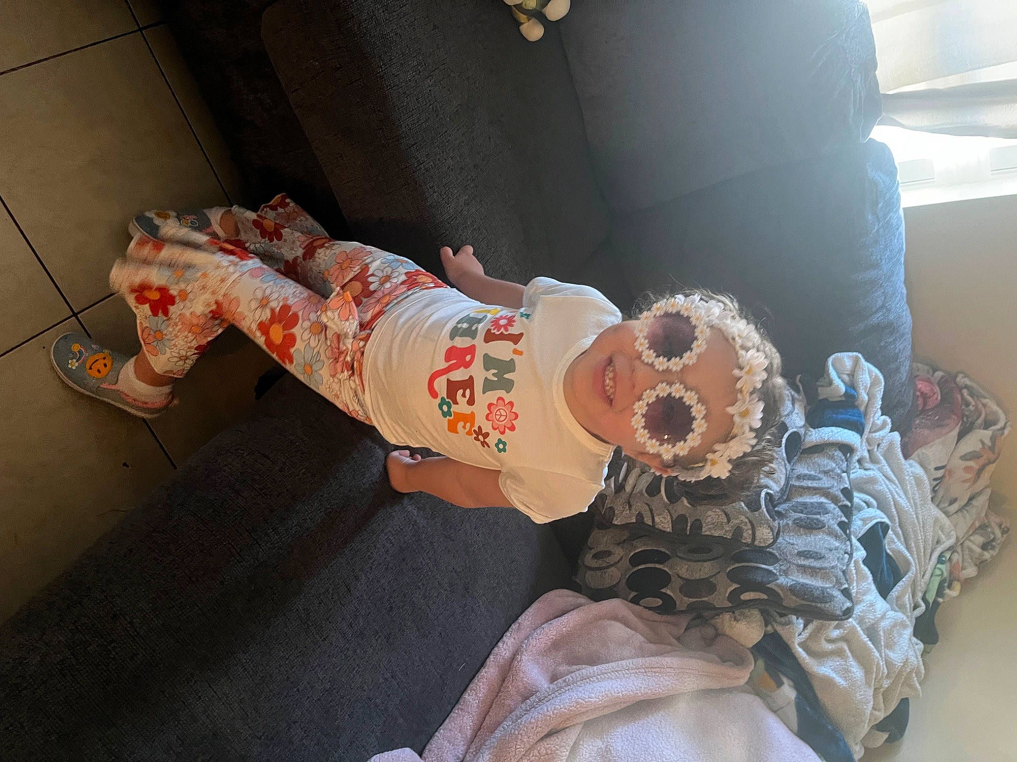 Addison is registered to the contest to win money with this photo: baby, baby_products, child, comfort, flesh, hat, headwear, human_leg, linens, peach, person, room, stuffed_toy, toddler, toy