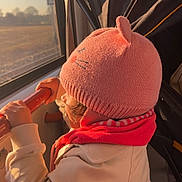 Maia participe au concours pour gagner de l'argent avec cette photo : bus, child, coat, curious, cute, handrail, hat, indoor, knit_hat, pink_hat, profile, public_transport, scarf, sunlight, toddler, travel, warm_light, window, winter_clothing, young_child