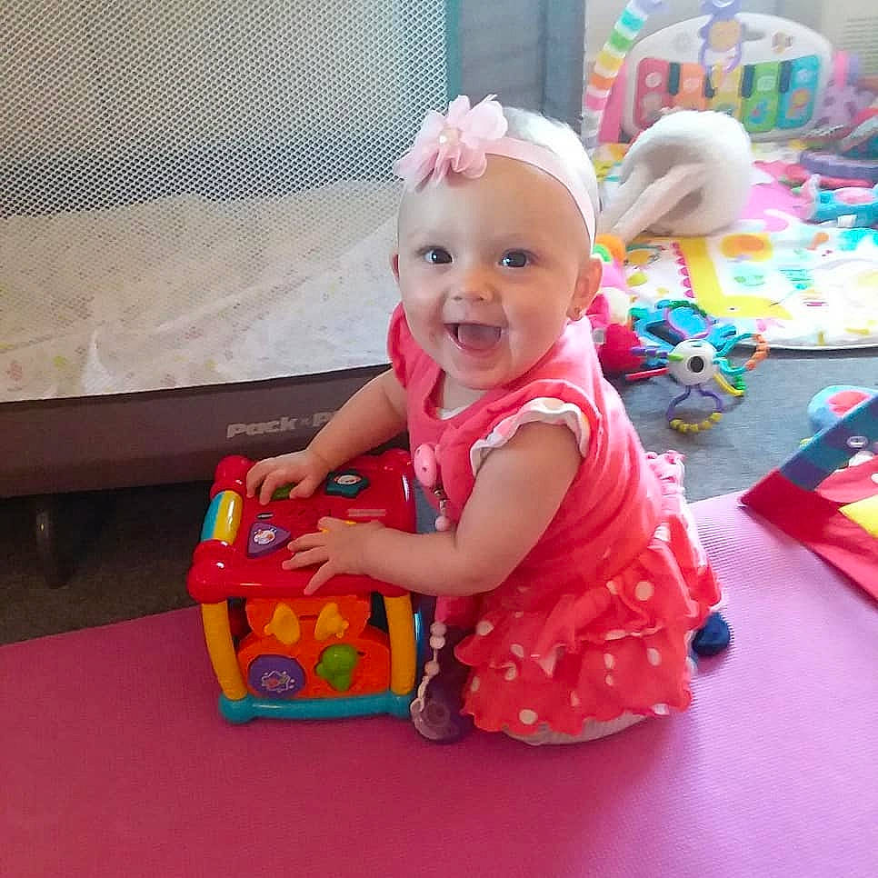 Anneliese joined the competition — help win amazing prizes! baby, baby_toys, child, dress, fun, person, play, playset, product, sitting, smile, toddler, toy