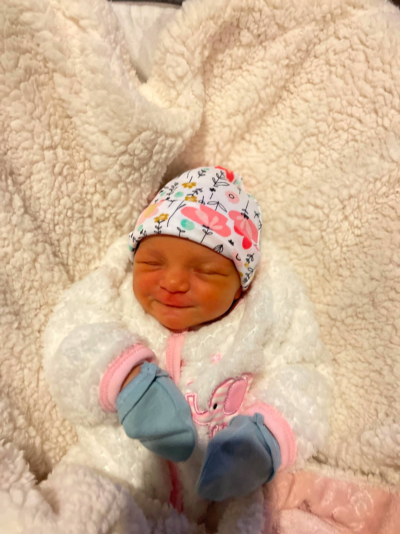 Winter is registered to the contest to win money with this photo: baby, beanie, cap, child, comfort, fashion_accessory, flooring, freezing, fur, happy, headgear, headwear, knit_cap, leisure, linens, person, smile, toddler, winter, wood