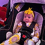 baby, infant, car_seat, yellow_bow, sunflower_pattern, onesie, child, face, seatbelt, straps, clothing, indoor, purple_light, headband, cute, sitting, young_child, person, portrait, newborn