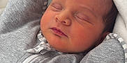 Emmalyn is registered to the contest to win money with this photo: newborn, baby, sleeping, blanket, grey_outfit, pacifier, soft_texture, closeup, indoor, cozy, cute, infant, face, head, peaceful, resting, person, portrait, warm, love_to_dream