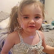 Rhea joined the competition — help win amazing prizes! toddler, child, girl, pigtails, floral_dress, bow, indoor, bedroom, bed, blanket, curly_hair, cute, face, portrait, young_child, person, skin, smile, clothing, hair