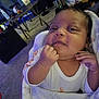 Journey is registered to the contest to win money with this photo: baby, infant, blanket, clothing, face, hand, indoors, carpet, table, chair, box, sitting, person, portrait, cute, expression, newborn, furniture, home, wrapped