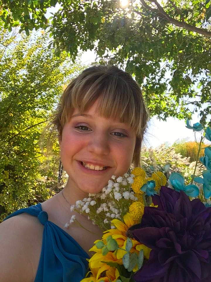 Hadleigh is registered to the contest to win money with this photo: annual_plant, bouquet, brown_hair, dress, electric_blue, floral_design, floristry, flower, flower_arranging, flowering_plant, formal_wear, fun, grass, happy, iris, joy, people_in_nature, person, petal, plant