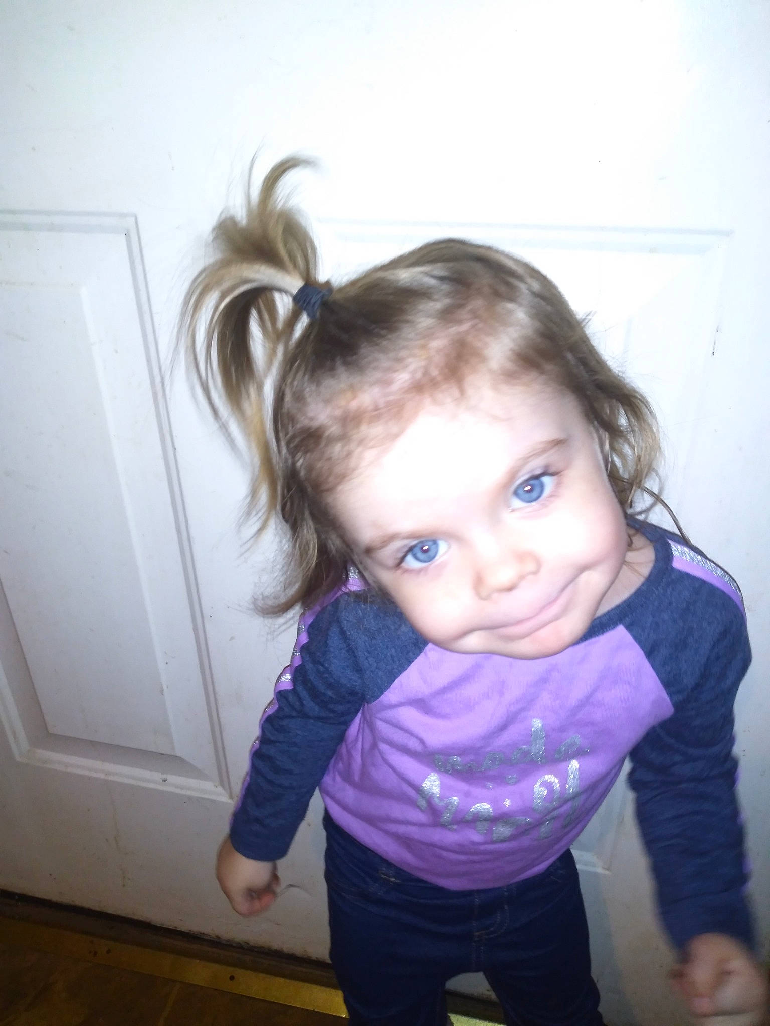 Paityn is registered to the contest to win money with this photo: arm, baby, blond, brown_hair, cheek, child, eye, face, fun, hair, hairstyle, head, iris, nose, person, purple, shoulder, skin, smile, standing