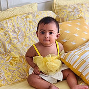 Avira joined the competition — help win amazing prizes! baby, child, infant, yellow, bed, pillow, cute, portrait, indoors, pattern, fabric, clothing, sitting, eyes, face, skin, person, soft, decor, comfortable