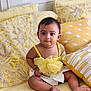 baby, child, infant, yellow, bed, pillow, cute, portrait, indoors, pattern, fabric, clothing, sitting, eyes, face, skin, person, soft, decor, comfortable