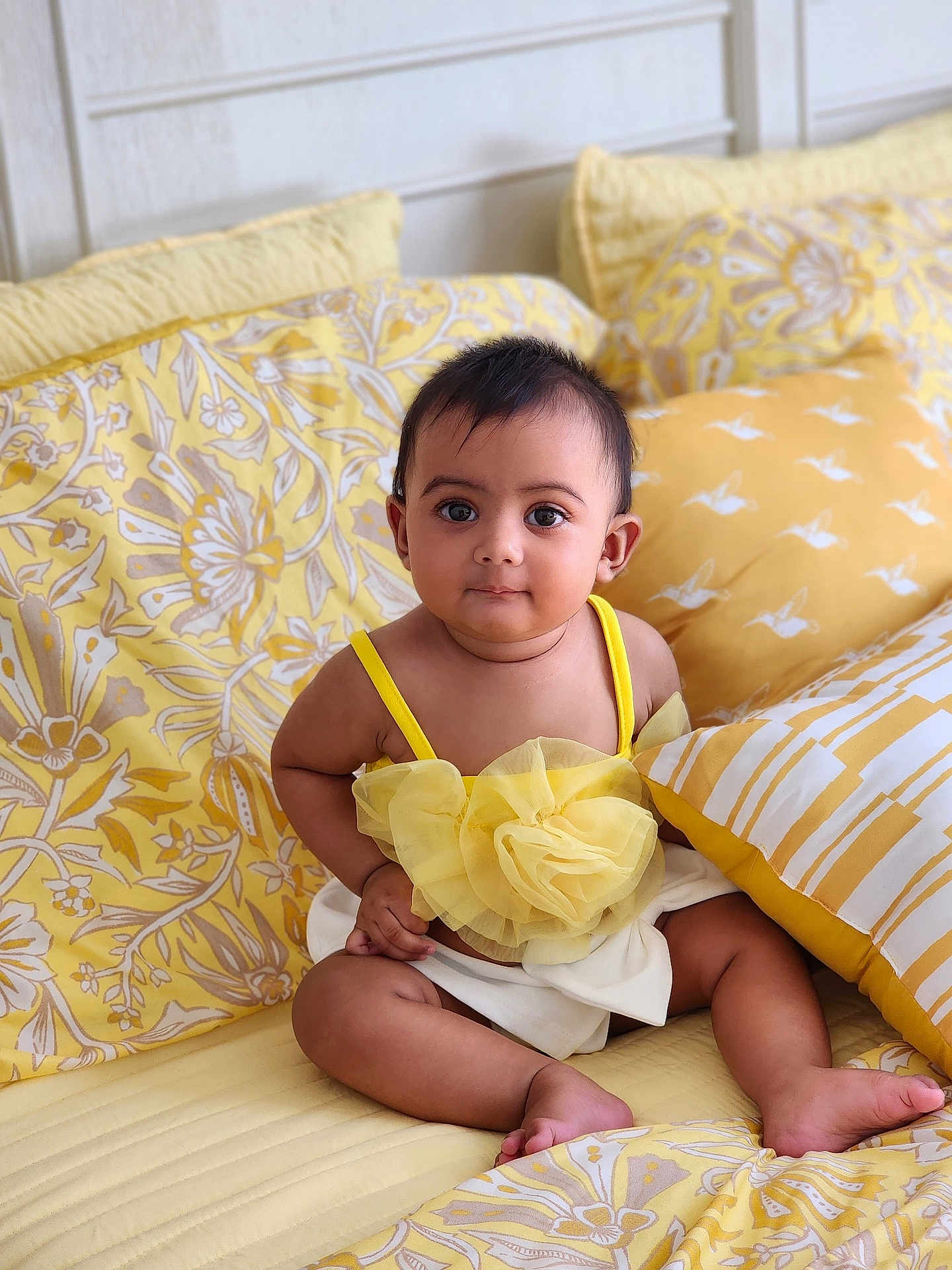 Avira joined the competition — help win amazing prizes! baby, child, infant, yellow, bed, pillow, cute, portrait, indoors, pattern, fabric, clothing, sitting, eyes, face, skin, person, soft, decor, comfortable