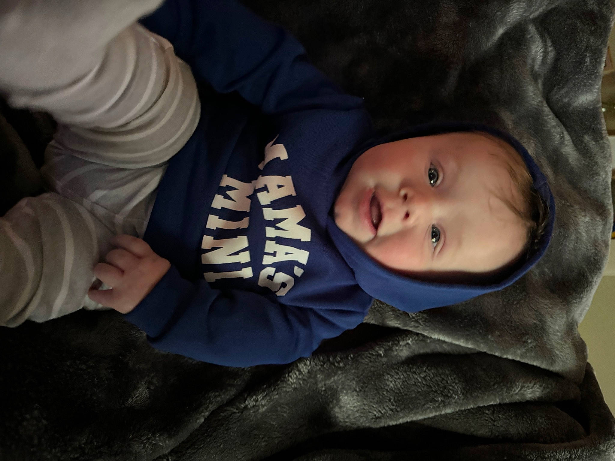 Carter is registered to the contest to win money with this photo: baby, baby_products, baby_toddler_clothing, cheek, child, comfort, fur, headgear, mammal, person, sitting, sleeve, thumb, toddler, tree, vertebrate, winter