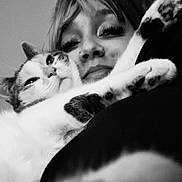 Jupiter is registered to the contest to win money with this photo: animal, black_and_white, cat, closeup, cozy, cute, eyelashes, face, fur, indoor, lock_screen, nose_ring, person, pet, phone, portrait, snuggling, technology, time_display, weather_info