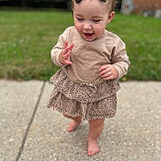 Isabella joined the competition — help win amazing prizes! barefoot, beige_top, bow, child, concrete, cute, daylight, grass, happy, headwear, nature, outdoor, person, playful, sidewalk, skirt, summer, toddler, walking, young_child