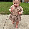 barefoot, beige_top, bow, child, concrete, cute, daylight, grass, happy, headwear, nature, outdoor, person, playful, sidewalk, skirt, summer, toddler, walking, young_child
