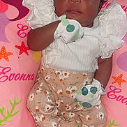 Evonna is registered to the contest to win money with this photo: baby, sleeping, infant, headband, bow, mittens, floral_pants, white_top, pillow, pink, sea_creatures, mermaid, starfish, jellyfish, cute, resting, child, indoors, soft_texture, peaceful