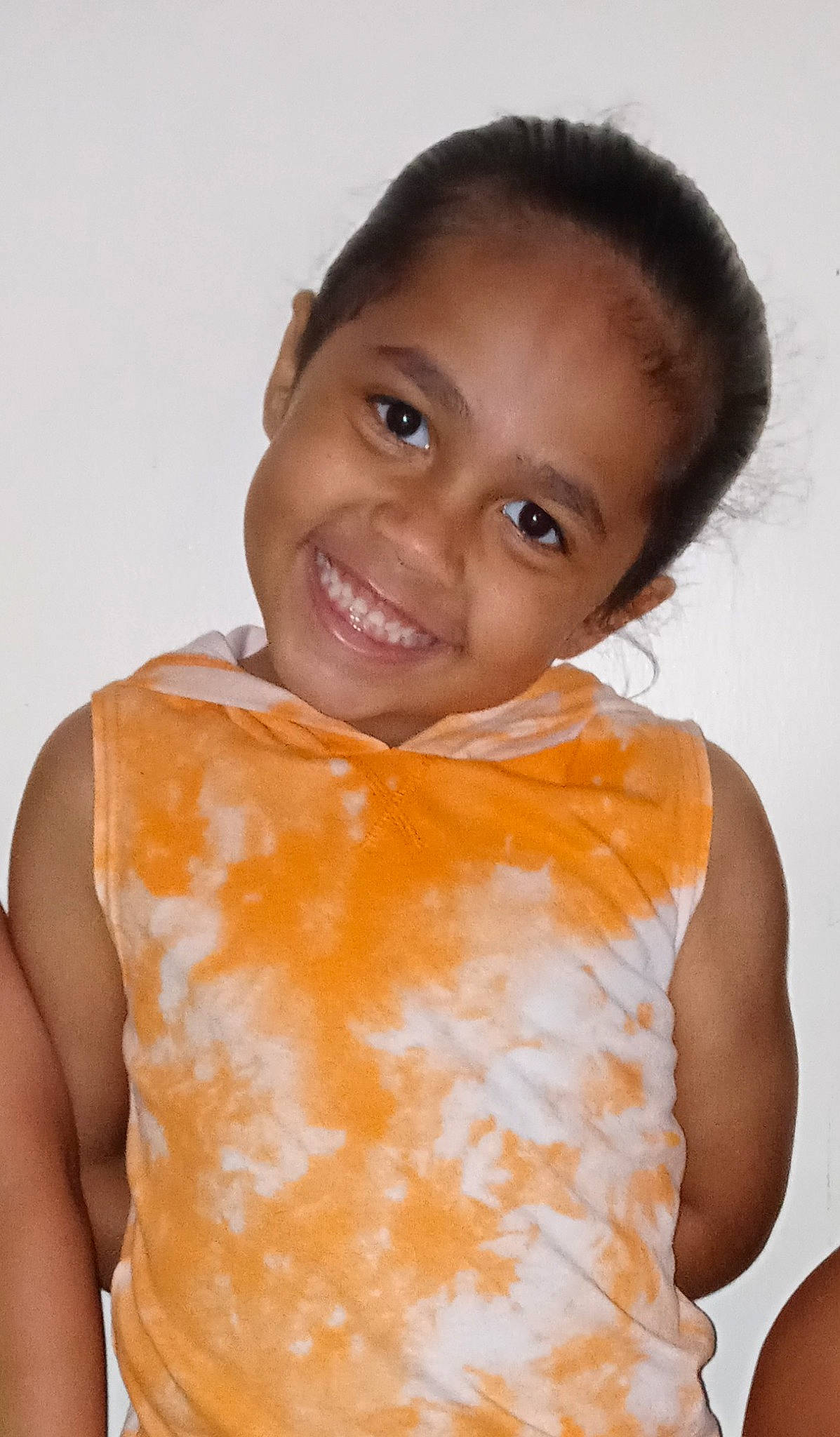 Hezekiah is registered to the contest to win money with this photo: cheek, chest, eyebrow, eyelash, flash_photography, forehead, hairstyle, happy, human_body, iris, joy, lip, neck, nose, orange, person, skin, sleeve, smile, t_shirt