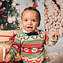 toddler, child, smiling, christmas_sweater, holiday, presents, decorations, lights, festive, indoors, happy, cute, face, portrait, winter, cozy, celebration, bow_tie, background, warm