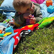Freya is registered to the contest to win money with this photo: baby, child, grass, blanket, toy, blocks, outdoor, sunlight, colorful, playing, infant, clothing, nature, happy, daylight, crawling, person, cute, toddler, greenery