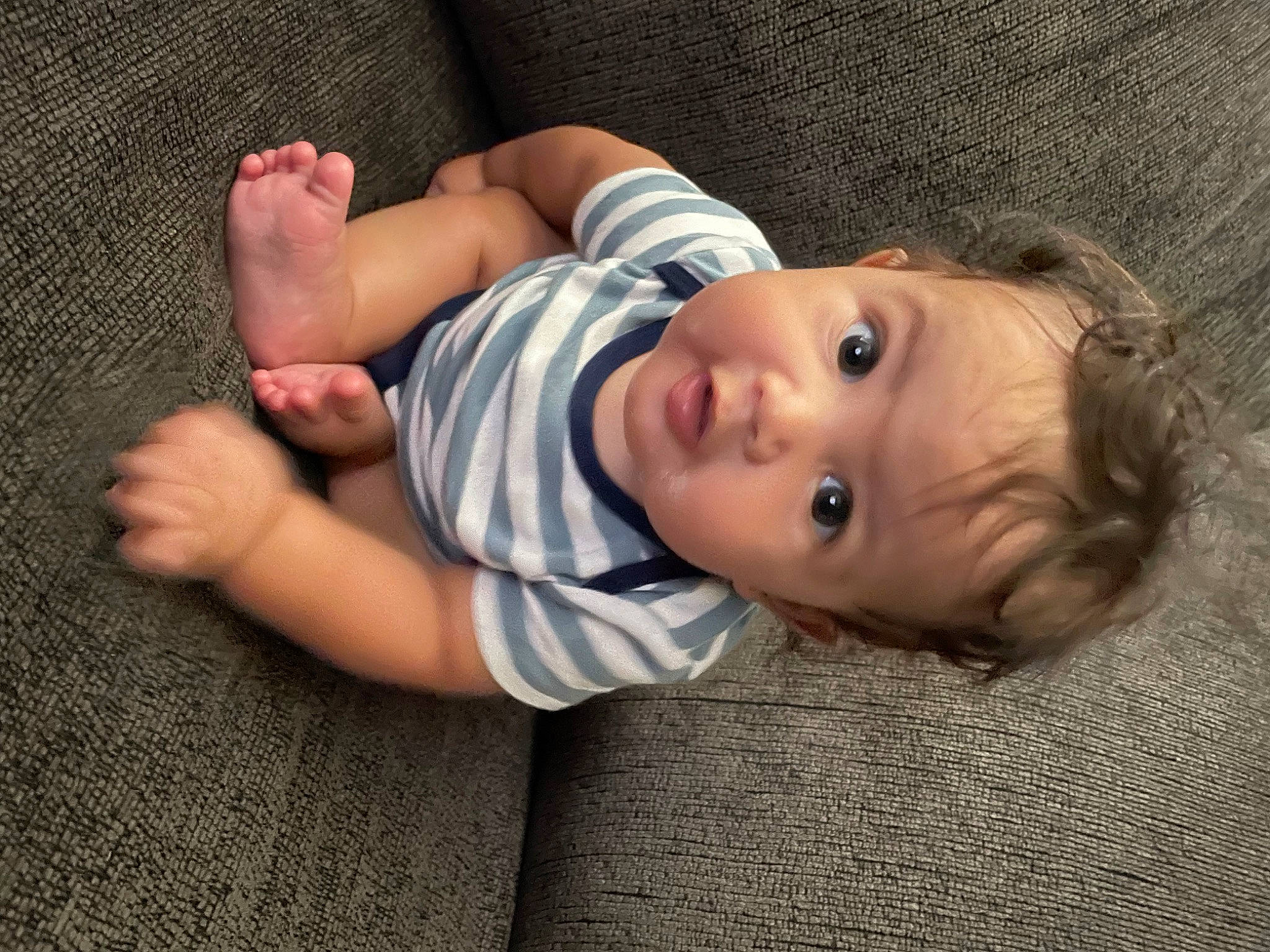 Brayson is registered to the contest to win money with this photo: baby, baby_toddler_clothing, cheek, comfort, dress, face, foot, gesture, grass, human_body, human_leg, iris, knee, lip, nose, person, skin, sleeve, surprise, toddler