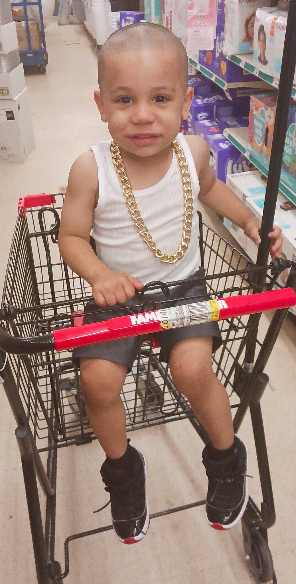 Zyaer Pritchett is registered to the contest to win money with this photo: child, eye, face, fun, human_leg, joy, knee, leg, leisure, person, photograph, retail, shoe, shopping_cart, shorts, sitting, skin, smile, snapshot, thigh