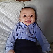 Odin joined the competition — help win amazing prizes! baby, smile, child, shirt, pillow, couch, happy, indoor, portrait, clothing, infant, person, furniture, seated, cute, young, face, sleeve, button, background