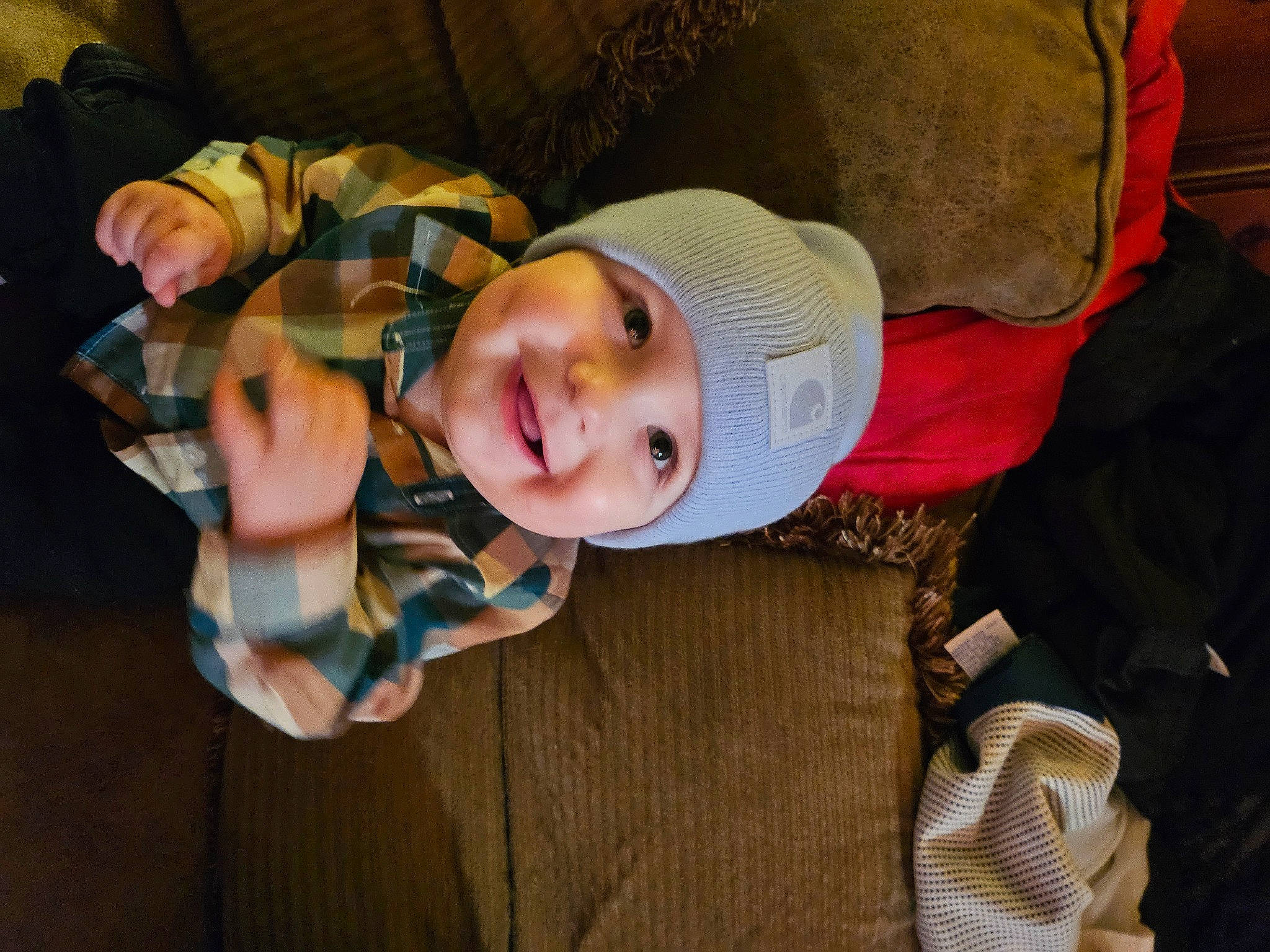 Zane is registered to the contest to win money with this photo: baby, baby_products, baby_toddler_clothing, cheek, child, comfort, fun, hat, headwear, joy, person, sitting, smile, toddler, tree, vacation, wood