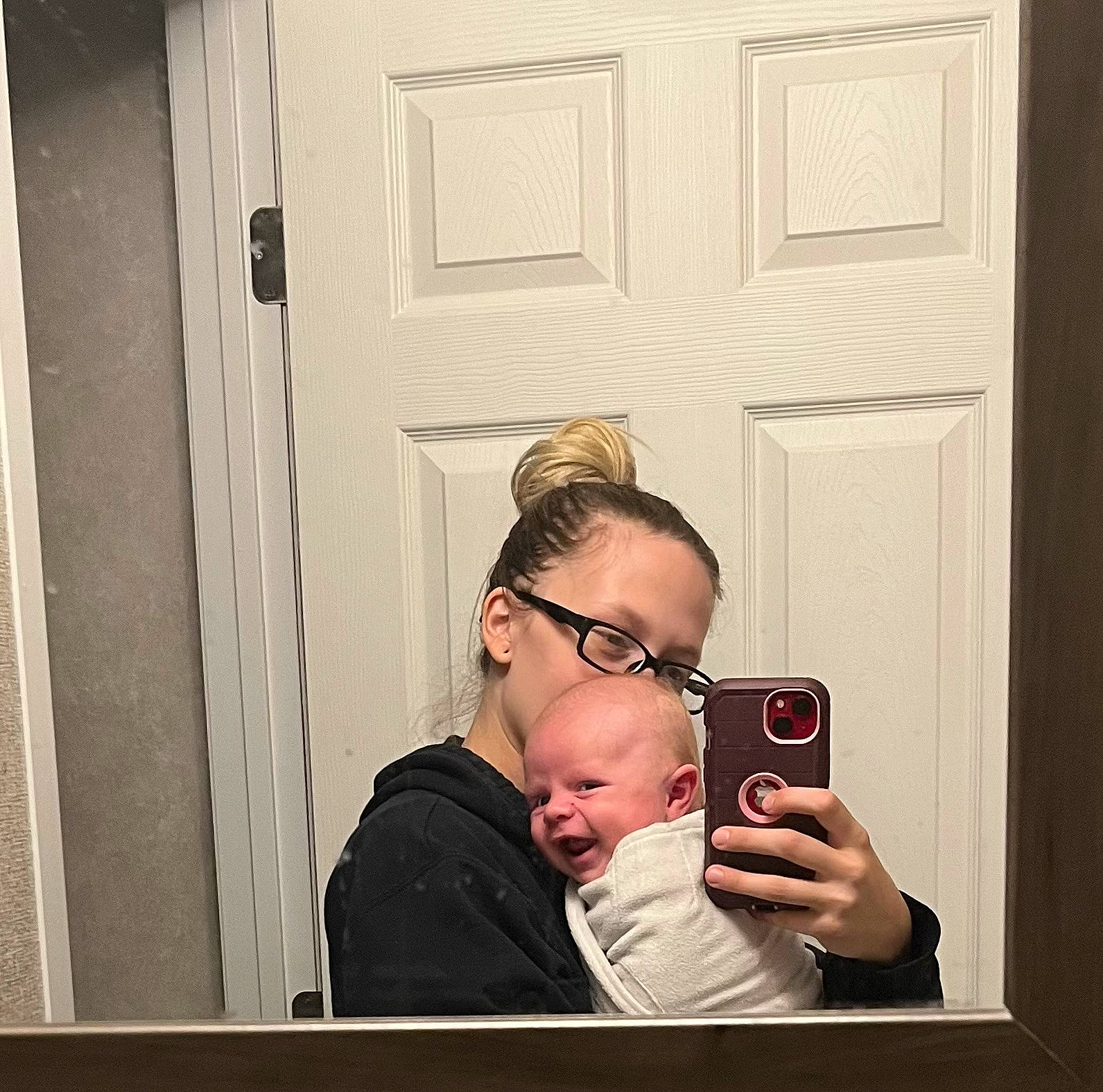 John is registered to the contest to win money with this photo: camera, camera_lens, cameras_optics, digital_camera, door, drinkware, eyewear, fun, gadget, gesture, glasses, hairstyle, home_door, person, photographer, room, selfie, single_lens_reflex_camera, sitting, vision_care