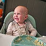 Wyatt is registered to the contest to win money with this photo: baby, baby_clothing, child, cute, face, feeding_time, food, green, happy, high_chair, indoor, infant, kitchen, mashed_food, mealtime, messy_face, plate, seat_belt, smiling, toddler