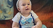 Wyatt is registered to the contest to win money with this photo: baby, blanket, bowtie, bunny_ears, child, couch, cozy, cute, happy, headband, indoor, infant, pajamas, playful, plush, portrait, seated, smiling, sock, whale_pattern