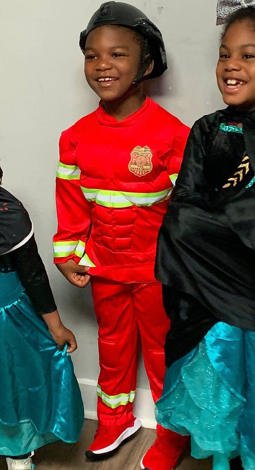 Idris is registered to the contest to win money with this photo: belt, child, electric_blue, event, fashion, fashion_design, fictional_character, fun, happy, head, joy, people, person, personal_protective_equipment, red, sleeve, smile, t_shirt, uniform, white