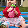 Lyla is registered to the contest to win money with this photo: baby, child, colorful_mat, curious, cute, daylight, face, foot, grass, hand, heart_pattern, outdoor, playtime, portrait, red_sweater, sippy_cup, sitting, skirt, summer, toy