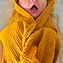 baby, child, blanket, yellow, wrapped, surprised, expression, face, head, mouth_open, eyes, texture, soft, towel, infant, cute, portrait, laying_down, fabric, cozy