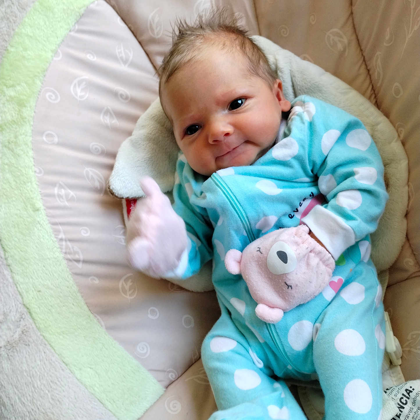 Cassie is registered to the contest to win money with this photo: baby, blue_onesie, child, comfort, cozy, cushion, cute, face, head, indoor, infant, mitten, newborn, pink_mitten, polka_dots, portrait, seat, sleepy, smiling, soft_fabric